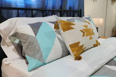 a group of pillows on a bed at Modern Oasis Studio - near LAX, SoFi, USC, DTLA in Los Angeles