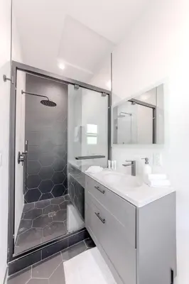 a white bathroom with a shower and a sink at Modern 5 Bed with Guest House & Pool West Hollywood in Los Angeles