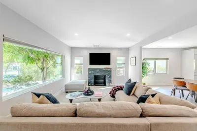 a living room with a large couch and a fireplace at Modern 5 Bed with Guest House & Pool West Hollywood in Los Angeles