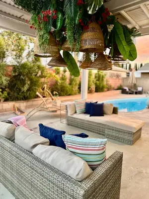 a patio with two wicker couches and a pool at Stunning Oasis with Pool by Disneyland and Knotts in Buena Park
