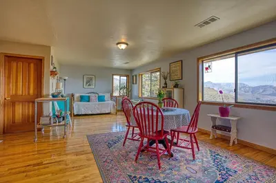 a living room with a table and red chairs at Camp David in Wofford Heights