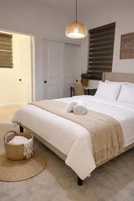 a bedroom with a large white bed with a basket at 85 hotel in Eastvale