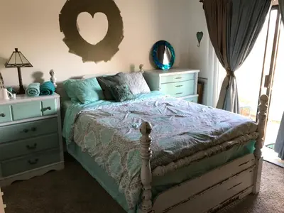 a bedroom with a bed and a dresser and a mirror at Ocean Condo Penthouse with Gym & Parking in Long Beach
