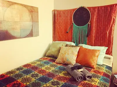 a bed with a colorful blanket and pillows on it at Ocean Condo Penthouse with Gym & Parking in Long Beach