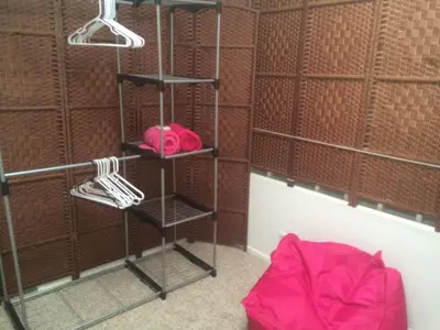 a shelf in a room with a pink hat and shoes at Ocean Condo Penthouse with Gym & Parking in Long Beach