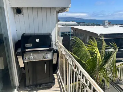 a grill on the side of a house on a balcony at Ocean View Penthouse 2 Bdrm 2 Bath w garage 2 Blocks to sand in Manhattan Beach