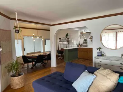 a living room with a blue couch and a table at 2BR LA Beach City House With Gym & Tesla Charging in Harbor City
