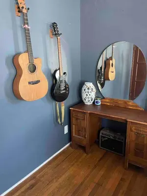 a room with guitars on the wall and a mirror at 2BR LA Beach City House With Gym & Tesla Charging in Harbor City