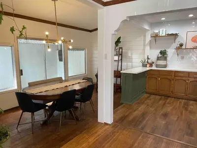 a dining room and kitchen with a table and chairs at 2BR LA Beach City House With Gym & Tesla Charging in Harbor City
