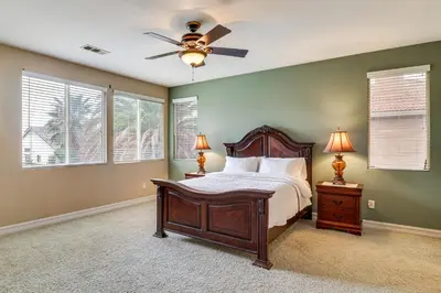 a bedroom with a bed and a ceiling fan at Pool, Patio and Games! Suburban Home in Palmdale in Palmdale