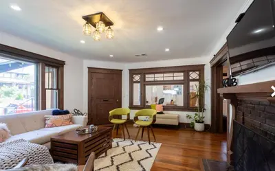 a living room with a couch and a fireplace at Historical Craftsman with Modern Amenities in Los Angeles
