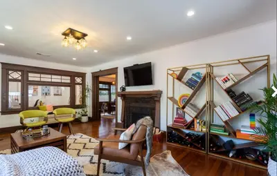 a living room with a couch and a fireplace at Historical Craftsman with Modern Amenities in Los Angeles