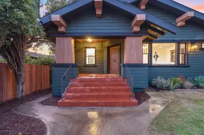 a blue house with stairs leading to the front door at Historical Craftsman with Modern Amenities in Los Angeles