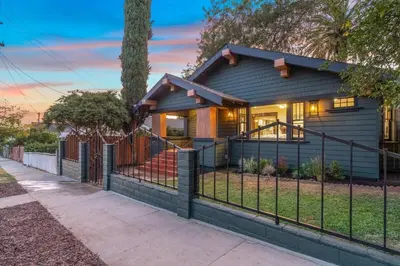 a house with a fence in front of it at Historical Craftsman with Modern Amenities in Los Angeles