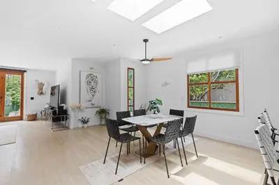 a white living room with a table and chairs at Luxury 4BR Villa with Private Pool in Los Angeles Crescent Heights in Los Angeles
