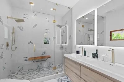 a white bathroom with a shower and a sink at Luxury 4BR Villa with Private Pool in Los Angeles Crescent Heights in Los Angeles