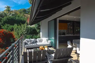 a patio with chairs and a table on a balcony at 2BR Luxury Villa in West Hollywood with Private Pool in Los Angeles