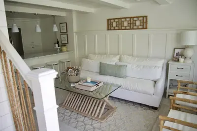 a living room with a white couch and a table at Exquisite Carpinteria Beach Cottage, Steps Away From The Beach in Carpinteria