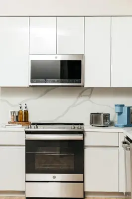 a kitchen with a stove and a microwave at Cozy 2B Apartment in Santa Monica in Los Angeles