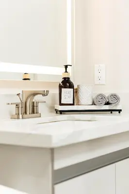 a bathroom sink with a bottle of soap on a tray at Cozy 2B Apartment in Santa Monica in Los Angeles