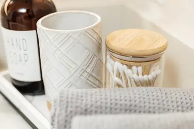 a jar of tooth brushes and a bottle of wine at Cozy 2B Apartment in Santa Monica in Los Angeles