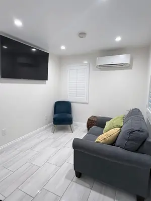 a living room with a couch and a chair at Cozy home in Norwalk