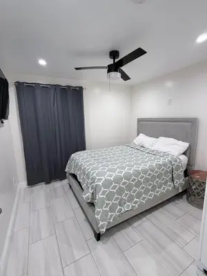 a bedroom with a bed and a ceiling fan at Cozy home in Norwalk