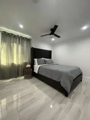 a bedroom with a bed and a ceiling fan at Cozy home in Norwalk
