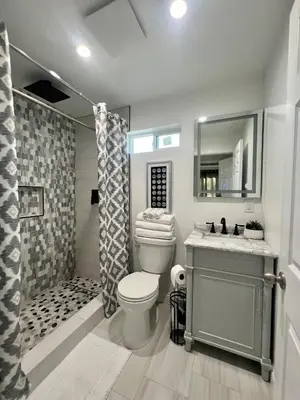 a bathroom with a toilet and a shower and a sink at Cozy home in Norwalk