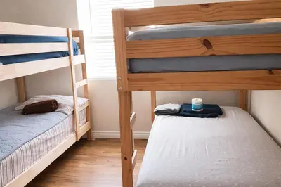 two bunk beds in a small room with a small bed at Santa Ana Love Home in Santa Ana