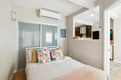 a bedroom with a bed with pillows on it at Sunny Santa Monica Retreat, Walk to Beach in Santa Monica