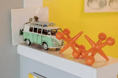 a toy bus with orange decorations on a shelf at Venice Beach House with beautiful private yard in Los Angeles