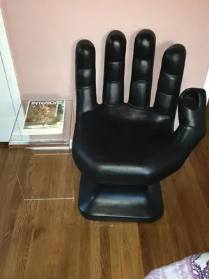 a black arm chair sitting next to a wall at Venice Beach House with beautiful private yard in Los Angeles
