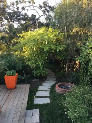 a garden with a path and a wooden deck at Venice Beach House with beautiful private yard in Los Angeles