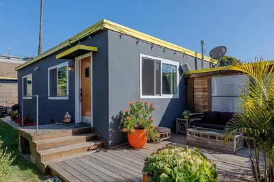 a blue tiny house on a wooden deck at Venice Beach House with beautiful private yard in Los Angeles