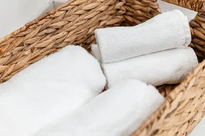 a basket filled with white towels on a table at Pacific Aura in Los Angeles