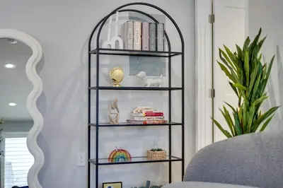 a shelf with books and other items in a room at A Fresh, Relaxing Oasis Near Monrovia Canyon Park in Duarte