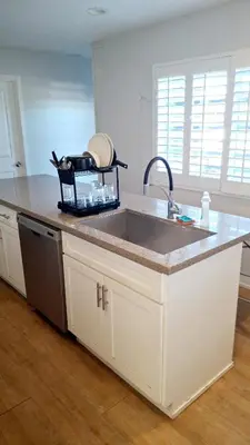a kitchen with a sink and a counter top at Normandie Vibes Hostel in Los Angeles