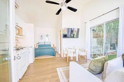 a living room with a bed and a table at Chic 6BR West Hollywood Villa with Jacuzzi in Los Angeles