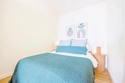a bedroom with a bed with a blue blanket at Chic 6BR West Hollywood Villa with Jacuzzi in Los Angeles
