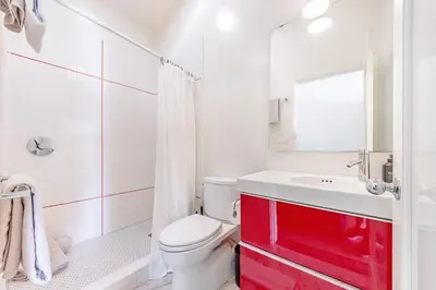 a white bathroom with a red cabinet and a sink at Chic 6BR West Hollywood Villa with Jacuzzi in Los Angeles