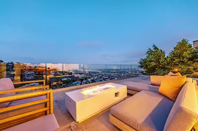 a living room with a couch and a view of a city at Hillside 4B Villa w Infinity Pool City Views in Los Angeles