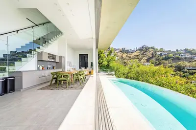 an open kitchen and dining area of a house with a swimming pool at Hillside 4B Villa w Infinity Pool City Views in Los Angeles