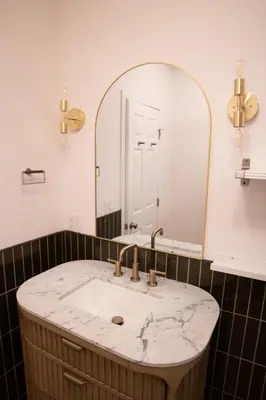 a bathroom with a marble sink and a mirror at Curated Central Location LA in Los Angeles