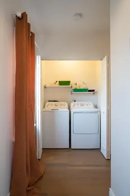 a laundry room with two washing machines in it at Curated Central Location LA in Los Angeles