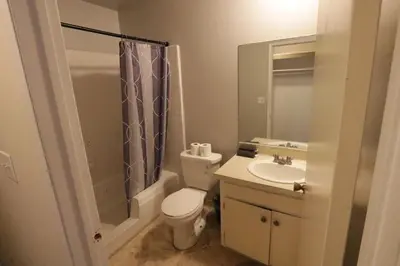 a bathroom with a toilet and a sink and a shower at Cozy Beverly Hills Hotel Style apartment in Los Angeles