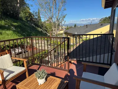 a balcony with a table and chairs and a fence at Skylight Terrace in Los Angeles