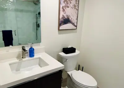 a bathroom with a white toilet and a sink at Cozy Century City 2 Br Sleeps 6 with Parking 505 in Los Angeles