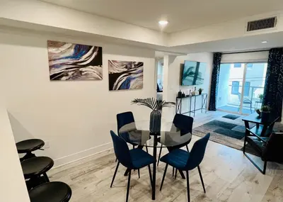a dining room with a glass table and blue chairs at Cozy Century City 2 Br Sleeps 6 with Parking 505 in Los Angeles