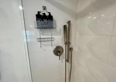 a bathroom with a shower stall with a basket at Cozy Century City 2 Br Sleeps 6 with Parking 505 in Los Angeles
